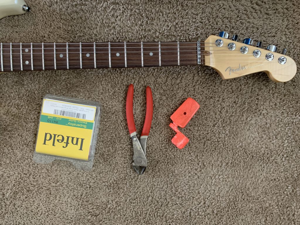 Guitar, strings, and tools