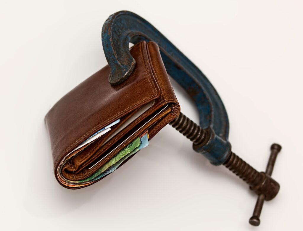 wallet being squeezed by c-clamp
